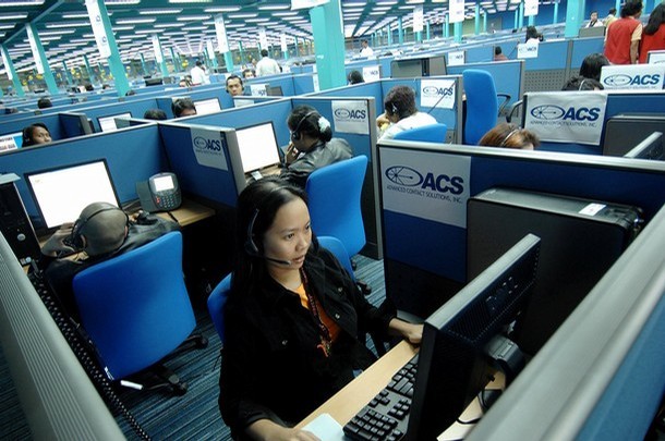 Filipino call center agents attend to US clients at the new branch of Advance Contact Solutions incorporated a call center facility that opened 1,600 jobs for call center professionals during the inauguration in Quezon city suburban Manila, 31 October 2007. The Philippines is expected to rake 13 billion USD in revenue or global market share of 10 percent and 600, 000 new jobs as President Gloria Arroyo endorsed  05 November the "Offshoring and Outsourcing Roadmap 2010" initiated by  the Business Processing Association of the Philippines.  AFP PHOTO/ROMEO GACAD T (Photo credit should read ROMEO GACAD/AFP/Getty Images)